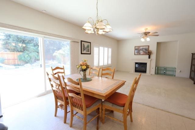 1976 Decatur Ave, Clovis, CA 93611 - dining area with a glass covered fireplace, a chandelier, light colored carpet, and a ceiling fan