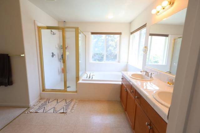 1976 Decatur Ave, Clovis, CA 93611 - full bath with a shower stall, double vanity, and a bath