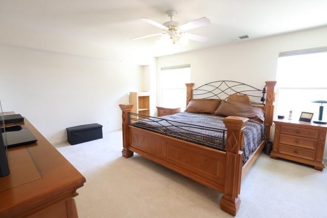 1976 Decatur Ave, Clovis, CA 93611 - bedroom with light colored carpet and a ceiling fan