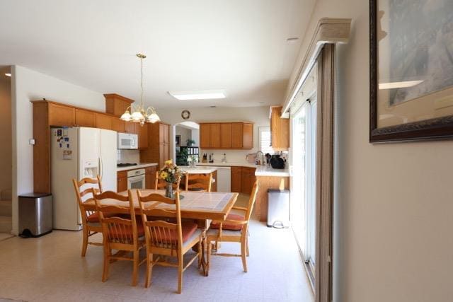 1976 Decatur Ave, Clovis, CA 93611 - dining room with light flooring and a chandelier