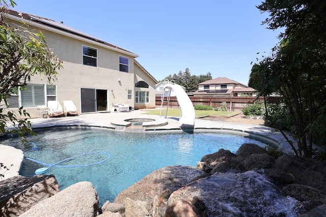 1976 Decatur Ave, Clovis, CA 93611 - view of swimming pool with a fenced backyard, a water slide, a patio area, and a pool with connected hot tub