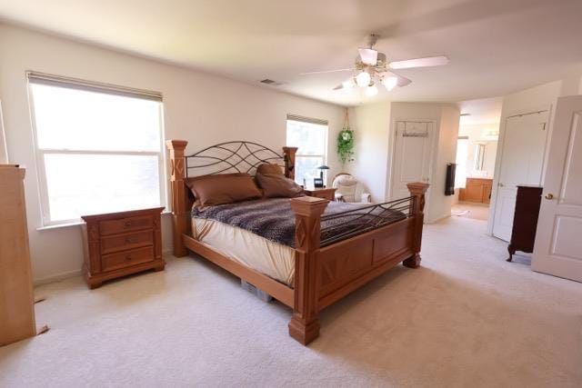 1976 Decatur Ave, Clovis, CA 93611 - bedroom featuring light carpet, ceiling fan, and ensuite bath