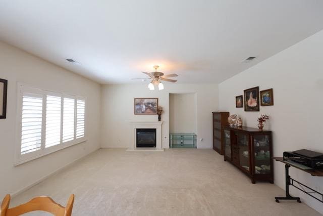 1976 Decatur Ave, Clovis, CA 93611 - living room featuring a ceiling fan, a glass covered fireplace, and carpet flooring