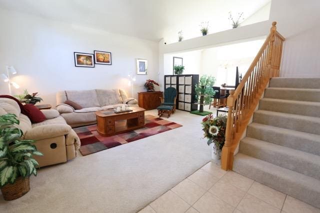 1976 Decatur Ave, Clovis, CA 93611 - living area featuring stairs, light tile patterned flooring, and light colored carpet