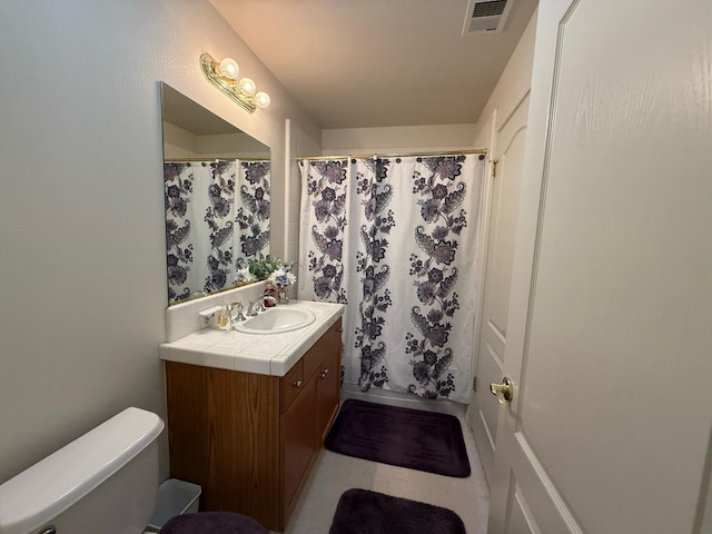 1976 Decatur Ave, Clovis, CA 93611 - full bathroom with vanity, toilet, tile patterned flooring, and a shower with curtain