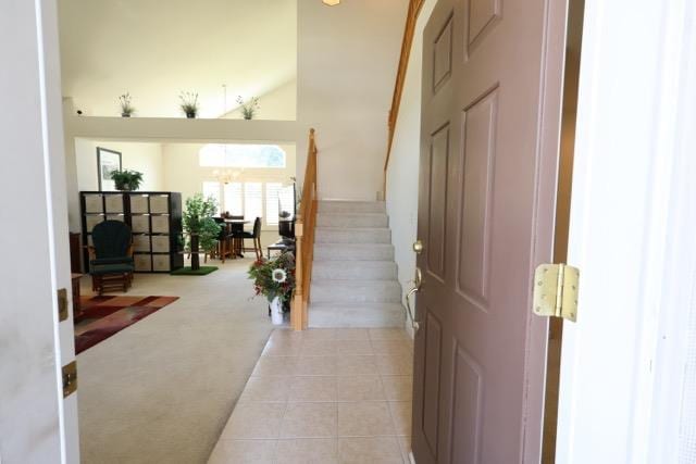 1976 Decatur Ave, Clovis, CA 93611 - entrance foyer with light colored carpet, stairs, light tile patterned flooring, a chandelier, and lofted ceiling