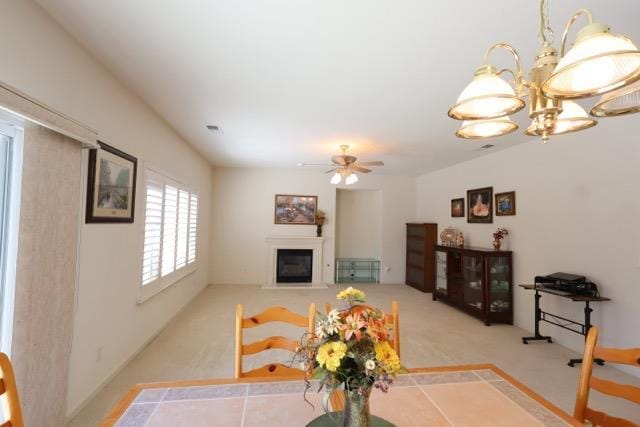 1976 Decatur Ave, Clovis, CA 93611 - living area with a glass covered fireplace, a ceiling fan, carpet floors, and a chandelier