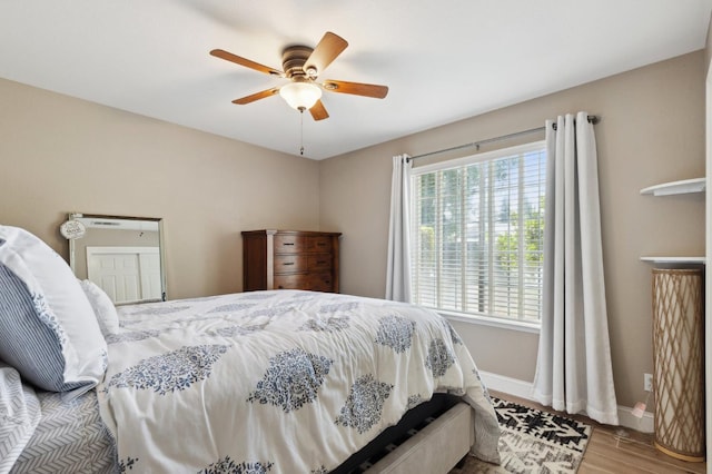 5860 W Menlo Ave, Fresno, CA 93722 - bedroom featuring wood finished floors, baseboards, and ceiling fan