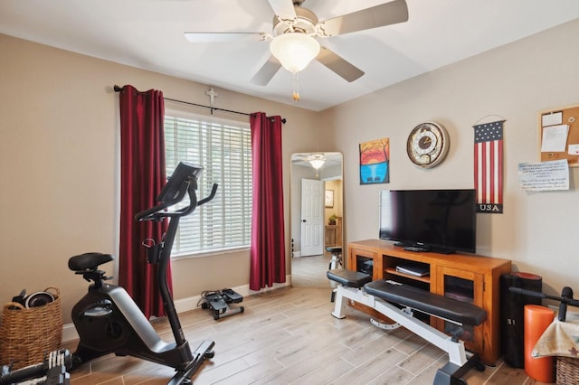 5860 W Menlo Ave, Fresno, CA 93722 - exercise room featuring healthy amount of natural light, a ceiling fan, wood finished floors, and baseboards