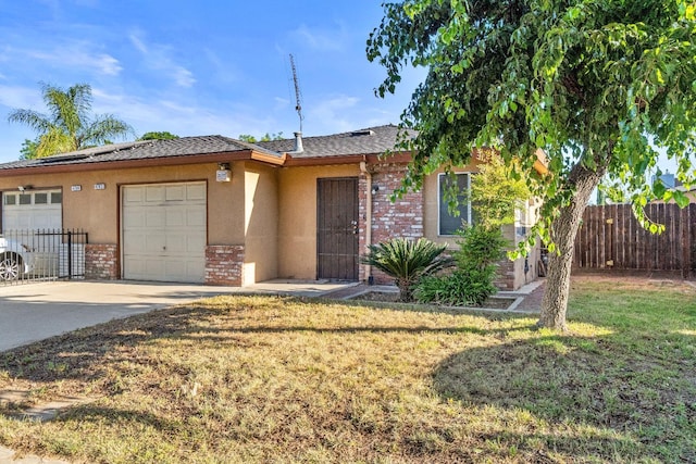 4782 W Austin Way, Fresno, CA 93722 - view of front of house with driveway, brick siding, a garage, and stucco siding