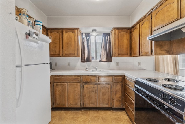 4782 W Austin Way, Fresno, CA 93722 - kitchen with freestanding refrigerator, black / electric stove, brown cabinets, a sink, and premium range hood