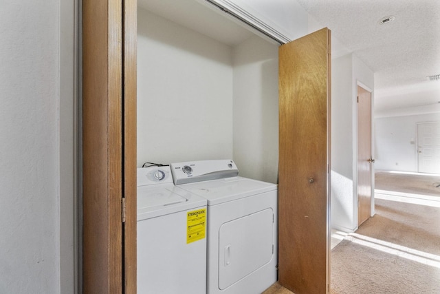 4782 W Austin Way, Fresno, CA 93722 - washroom with washing machine and dryer, light colored carpet, and a textured ceiling