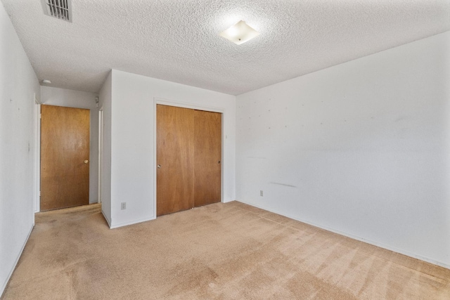 4782 W Austin Way, Fresno, CA 93722 - unfurnished bedroom featuring carpet flooring, a closet, and a textured ceiling