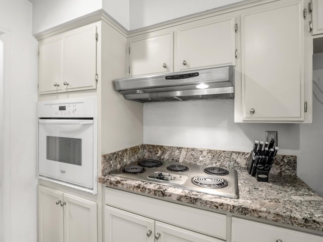 7352 N Adoline Ave, Fresno, CA 93711 - kitchen featuring under cabinet range hood, oven, stainless steel stovetop, and white cabinets