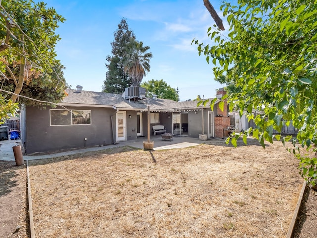 7352 N Adoline Ave, Fresno, CA 93711 - back of property with stucco siding, a patio, central AC unit, a shingled roof, and a chimney