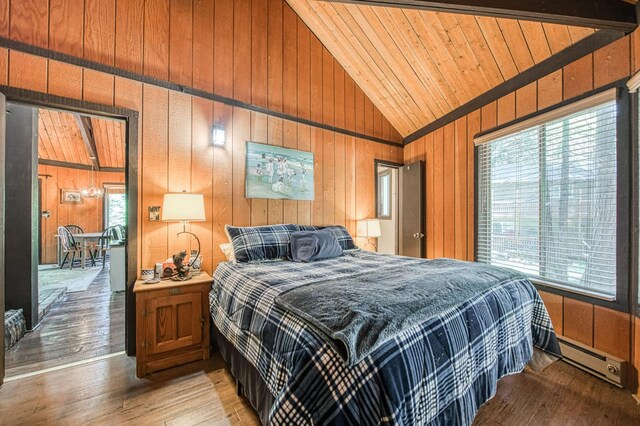 42272 Hanging Branch Rd, Shaver Lake, CA 93664 - bedroom featuring vaulted ceiling, multiple windows, wooden walls, light wood-style flooring, and wooden ceiling