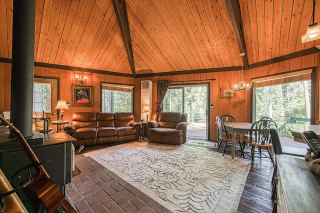 42272 Hanging Branch Rd, Shaver Lake, CA 93664 - living area featuring high vaulted ceiling, healthy amount of natural light, wooden walls, and wood ceiling with exposed beams
