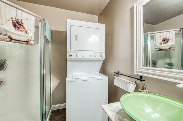 42272 Hanging Branch Rd, Shaver Lake, CA 93664 - laundry room featuring stacked washer / drying machine and dark wood-style floors