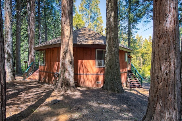 42272 Hanging Branch Rd, Shaver Lake, CA 93664 - view of side of property featuring crawl space, stairway, a shingled roof, and a forest view