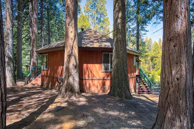 42272 Hanging Branch Rd, Shaver Lake, CA 93664 - view of home's exterior featuring crawl space, stairs, roof with shingles, and a view of trees
