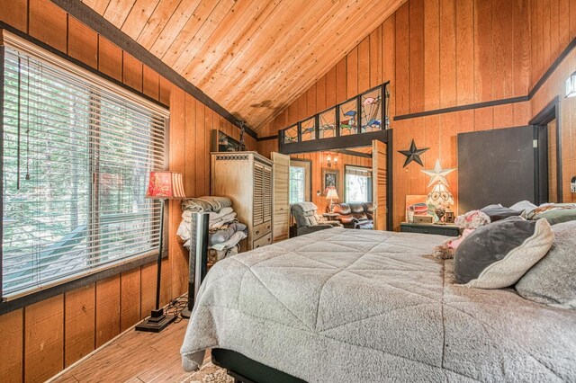 42272 Hanging Branch Rd, Shaver Lake, CA 93664 - bedroom with hardwood / wood-style floors, wood walls, multiple windows, wooden ceiling, and high vaulted ceiling