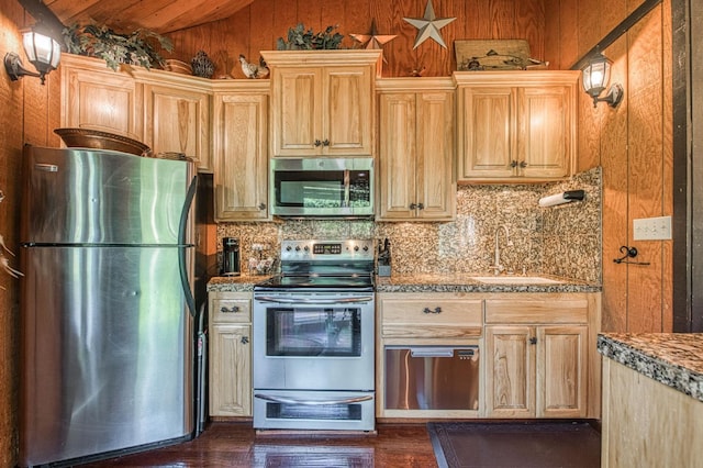 42272 Hanging Branch Rd, Shaver Lake, CA 93664 - kitchen featuring stainless steel appliances, lofted ceiling, decorative backsplash, a sink, and wood walls