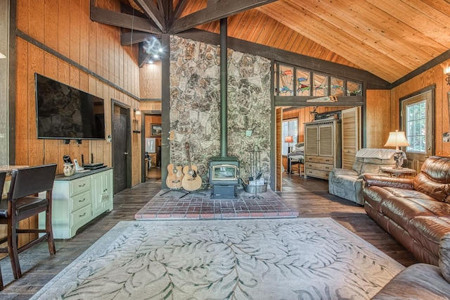 42272 Hanging Branch Rd, Shaver Lake, CA 93664 - living area featuring high vaulted ceiling, a wood stove, wood walls, dark wood-type flooring, and wood ceiling