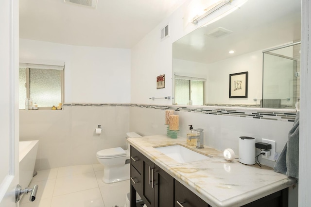 5309 N Parrish Way, Fresno, CA 93711 - full bath with vanity, tile walls, toilet, tile patterned floors, and a shower with door