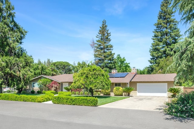 5309 N Parrish Way, Fresno, CA 93711 - view of front of home featuring a garage, concrete driveway, and solar panels
