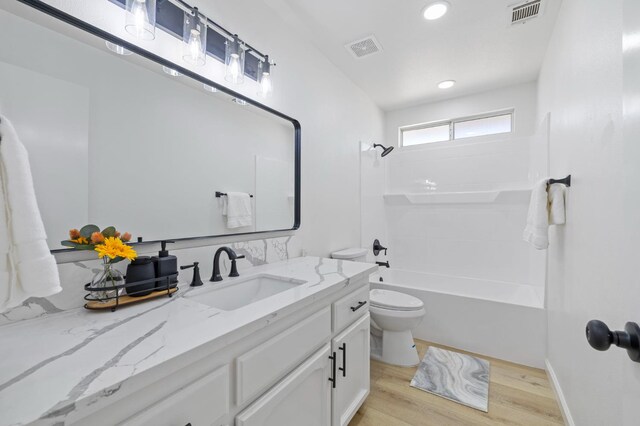 20434 Olympia Rd, Madera, CA 93638 - bathroom featuring vanity, toilet, wood finished floors,  shower combination, and recessed lighting