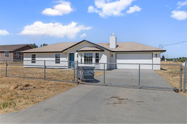 20434 Olympia Rd, Madera, CA 93638 - ranch-style home featuring driveway, an attached garage, a fenced front yard, a chimney, and stucco siding