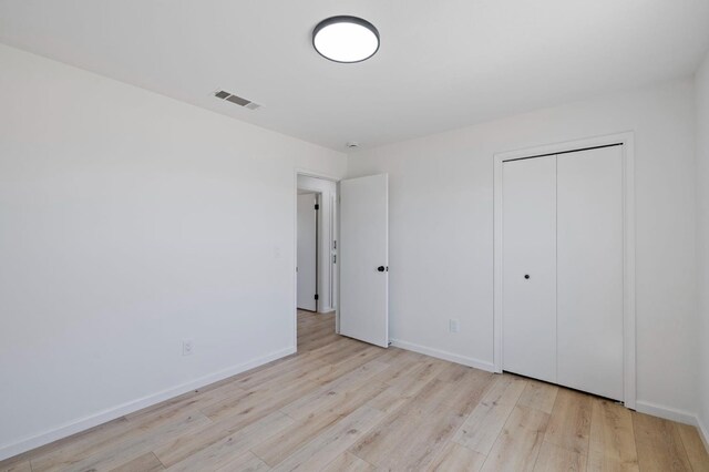 20434 Olympia Rd, Madera, CA 93638 - unfurnished bedroom featuring wood finished floors, baseboards, and a closet