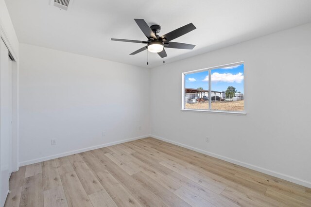 20434 Olympia Rd, Madera, CA 93638 - empty room featuring light wood finished floors, baseboards, and a ceiling fan
