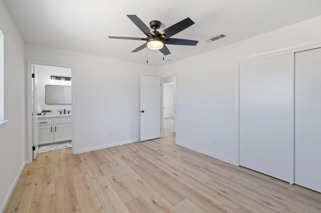 20434 Olympia Rd, Madera, CA 93638 - unfurnished bedroom featuring light wood-style flooring, a closet, connected bathroom, and baseboards