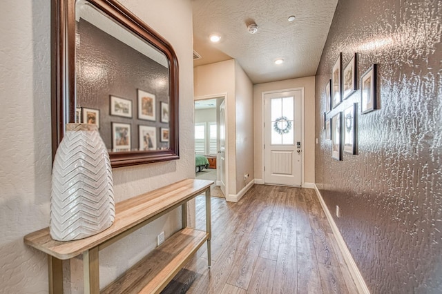 574 Expedition Way, Madera, CA 93636 - foyer entrance featuring hardwood / wood-style floors, baseboards, a textured ceiling, and a textured wall