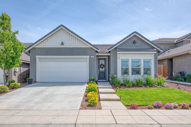 574 Expedition Way, Madera, CA 93636 - view of front facade featuring driveway, a garage, stucco siding, and a tile roof