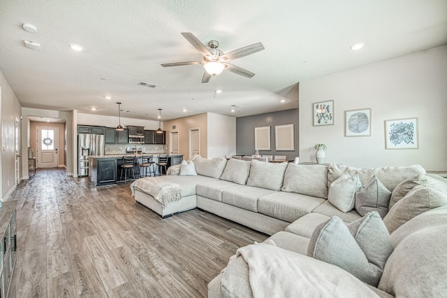 574 Expedition Way, Madera, CA 93636 - living room featuring light wood-type flooring, a ceiling fan, recessed lighting, and baseboards