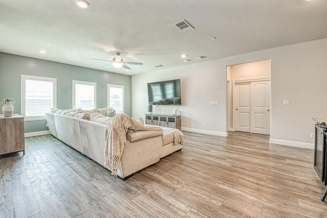 574 Expedition Way, Madera, CA 93636 - living area with a ceiling fan, light wood-style flooring, baseboards, a textured ceiling, and recessed lighting
