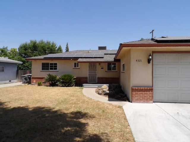 4321 Buckingham Way, Fresno, CA 93726 - single story home featuring brick siding, solar panels, a front lawn, an attached garage, and stucco siding