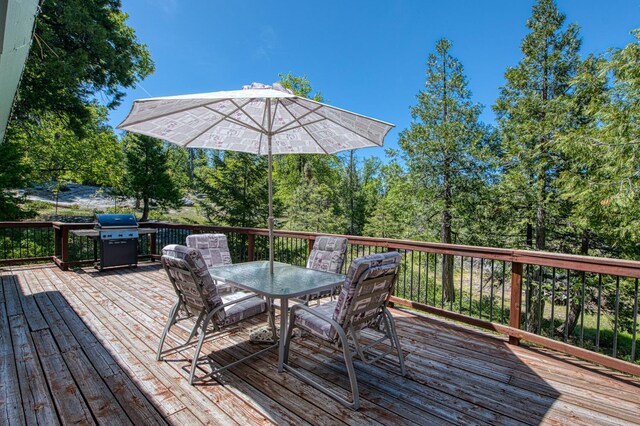 42010 Granite Ledge Ln, Shaver Lake, CA 93664 - wooden deck featuring outdoor dining space and a grill
