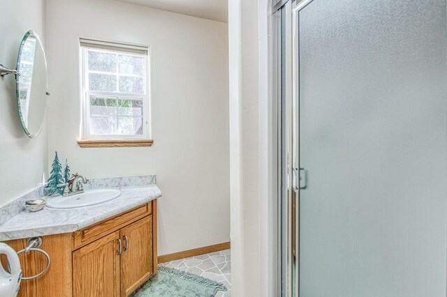 42010 Granite Ledge Ln, Shaver Lake, CA 93664 - bathroom featuring vanity, a shower stall, and baseboards