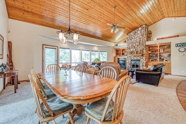 42010 Granite Ledge Ln, Shaver Lake, CA 93664 - dining room with light carpet, wood ceiling, a ceiling fan, a stone fireplace, and high vaulted ceiling