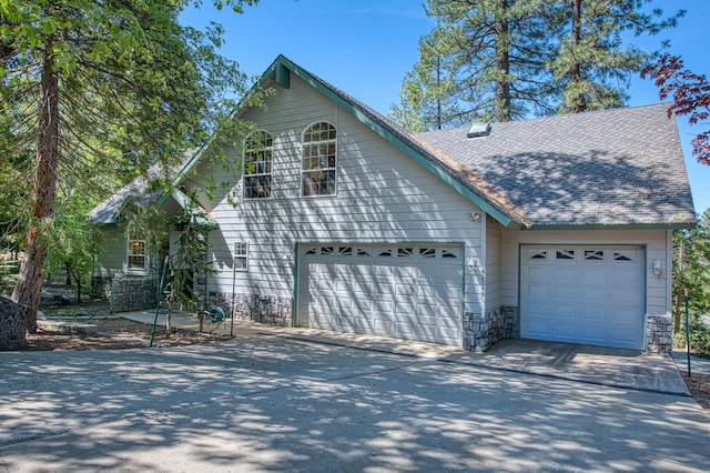 42010 Granite Ledge Ln, Shaver Lake, CA 93664 - view of front facade with driveway, a garage, and a shingled roof