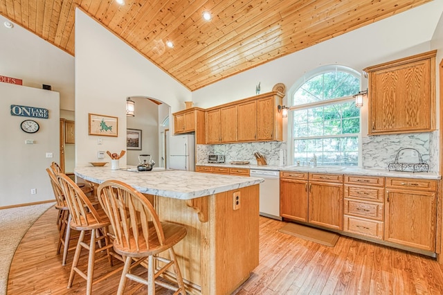 42010 Granite Ledge Ln, Shaver Lake, CA 93664 - kitchen featuring white appliances, wood ceiling, a sink, arched walkways, and light countertops