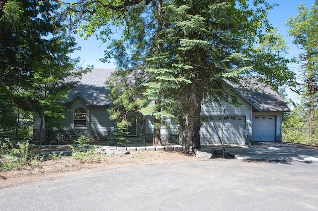 42010 Granite Ledge Ln, Shaver Lake, CA 93664 - view of front of home with driveway, an attached garage, and a shingled roof