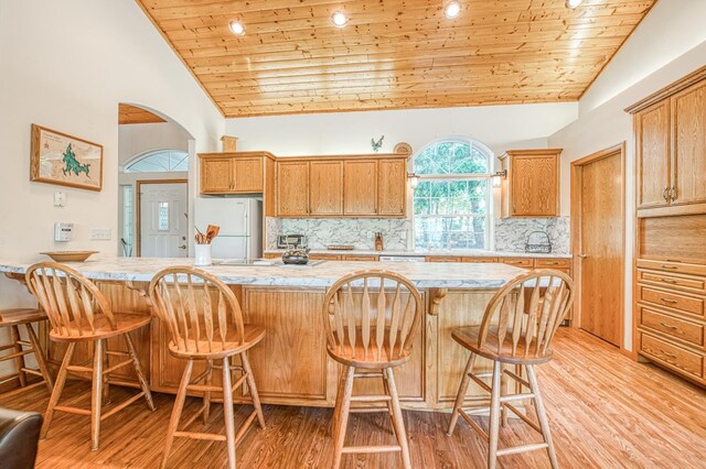 42010 Granite Ledge Ln, Shaver Lake, CA 93664 - kitchen featuring freestanding refrigerator, wooden ceiling, light wood finished floors, light countertops, and decorative backsplash