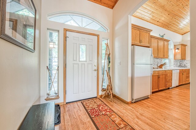 42010 Granite Ledge Ln, Shaver Lake, CA 93664 - foyer entrance featuring light wood-style flooring, wood ceiling, plenty of natural light, and arched walkways