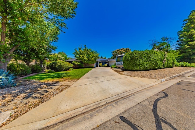 1096 Twain Ave W, Fresno, CA 93711 - view of property hidden behind natural elements with a front yard and concrete driveway
