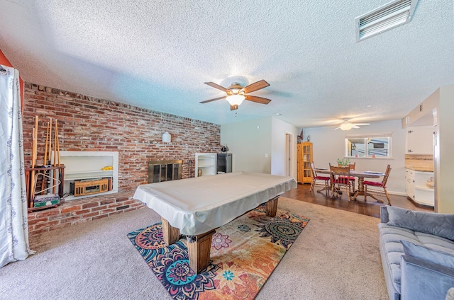 1096 Twain Ave W, Fresno, CA 93711 - recreation room with a ceiling fan, billiards, a textured ceiling, a fireplace, and carpet floors