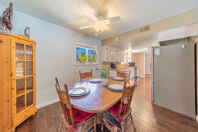 1096 Twain Ave W, Fresno, CA 93711 - dining area with a textured ceiling, dark wood-type flooring, a ceiling fan, and baseboards